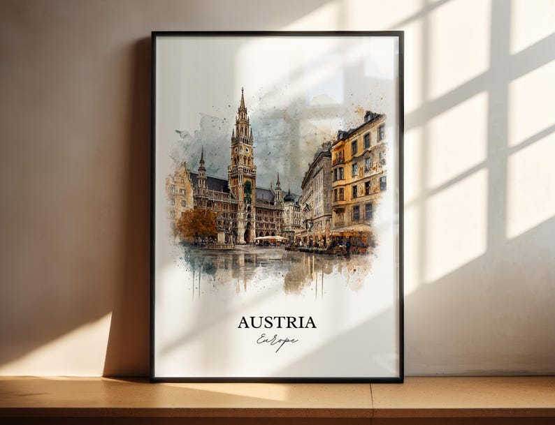 May include: Framed watercolour print depicting a European city, with a prominent clock tower and surrounding buildings. The print has a watercolour effect, with the words "AUSTRIA" and "Europe" in script.