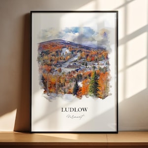 May include: A watercolor painting of a town in the mountains. The town is surrounded by trees and snow. The painting is in a black frame and has the text "Ludlow, Vermont" at the bottom.