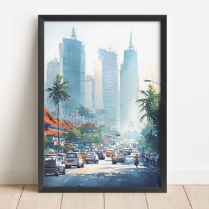 May include: Framed watercolor print of a city street scene. The artwork depicts tall buildings, palm trees, and traffic on a sunny day. The color palette includes blues, oranges, and greens. The print is in a black frame.