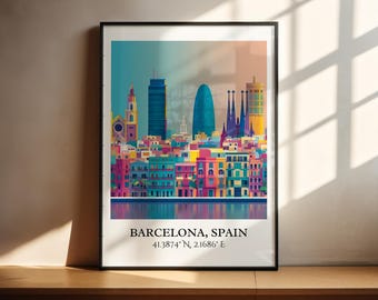 May include: A framed art print of Barcelona, Spain, featuring a colorful cityscape. The print showcases iconic buildings in shades of blue, pink, yellow, and green. The text "BARCELONA, SPAIN" and coordinates are at the bottom.