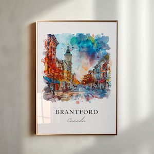Könnte beinhalten: Aquarelldruck einer Straßenszene in Brantford, Kanada, goldgerahmt. Das Kunstwerk zeigt eine farbenfrohe Darstellung von Gebäuden und einer Straße, mit dem Namen der Stadt und des Landes darunter.