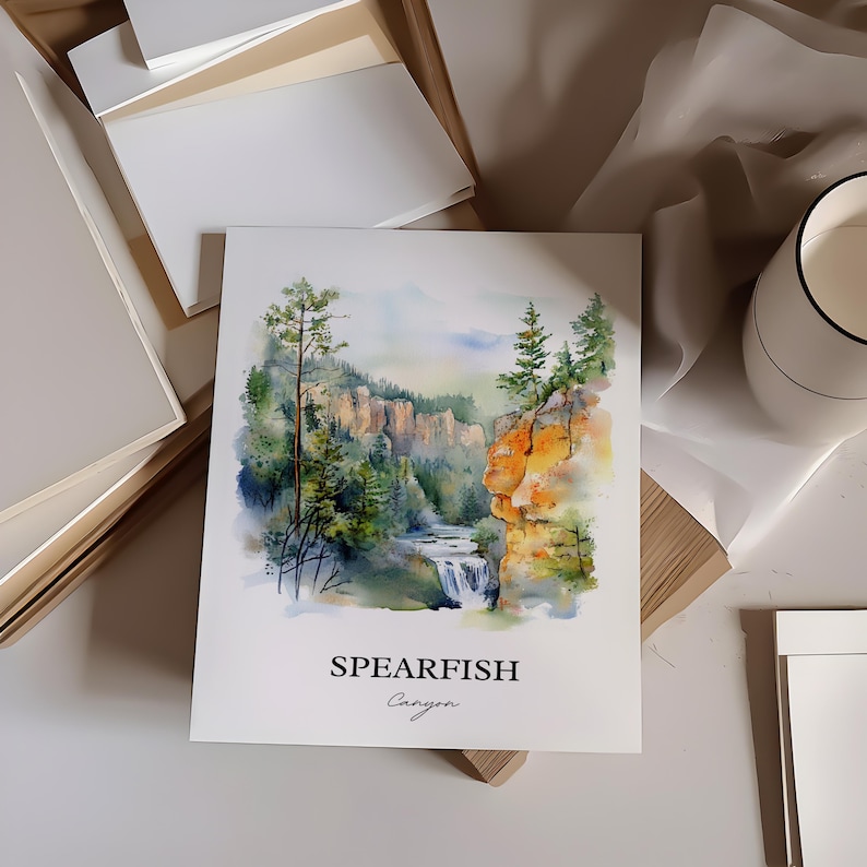 May include: Watercolor painting of Spearfish Canyon, a scenic landscape with a waterfall cascading down a rocky cliffside. Lush green trees line the canyon walls, and the sky is a soft blue with wispy clouds.