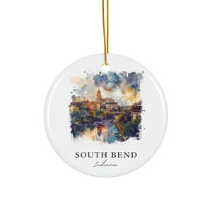 May include: A watercolour-style illustration of the South Bend, Indiana skyline. The image features a cityscape with buildings and a river, with a watercolour wash effect in shades of blue, green, and brown. The text "SOUTH BEND Indiana" is printed below the image.