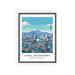 May include: A framed art print featuring a colorful illustration of Daegu, South Korea. The artwork depicts a cityscape with mountains, a tower, and buildings in various colors. Text at the bottom reads "DAEGU, SOUTH KOREA" and coordinates.