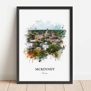 May include: Framed watercolor print of McKinney, Texas, featuring a detailed aerial view of the city with a prominent church steeple. The artwork has a watercolor effect with splashes of color and the text "McKinney Texas" at the bottom.