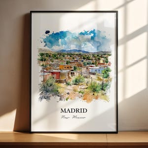 May include: A watercolor painting of a small town with colorful buildings and a blue sky. The town is called Madrid, New Mexico.
