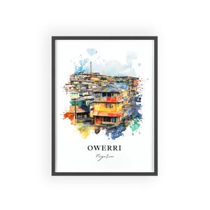 May include: Framed watercolor print of Owerri, Nigeria. The artwork depicts colorful buildings with a vibrant, artistic flair. The word "Owerri" is printed in a bold font, with "Nigeria" below it in a script font.