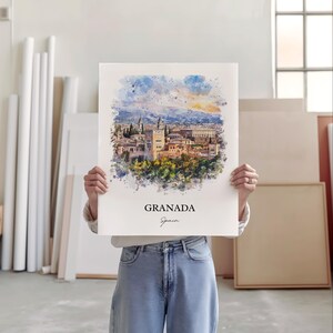 May include: A watercolor painting of the Alhambra palace in Granada, Spain. The painting is in a white frame and has a white background. The text "GRANADA" and "Spain" is written in black at the bottom of the painting.