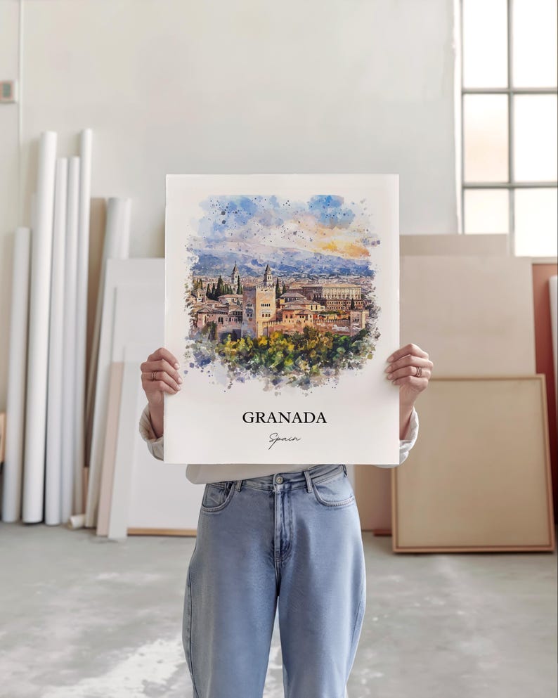 May include: A watercolor painting of the Alhambra palace in Granada, Spain. The painting is in a white frame and has a white background. The text "GRANADA" and "Spain" is written in black at the bottom of the painting.