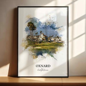 May include: Framed watercolor print of Oxnard, California, featuring palm trees, buildings, and a golf course. The artwork has a colorful, abstract background with the city name and state written below.