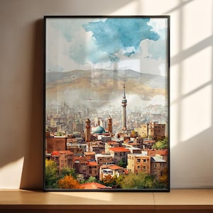 May include: Framed watercolor print of a cityscape with a tall tower and a blue-domed building. The artwork depicts a vibrant city scene with buildings, mountains, and a cloudy sky. The frame is black.