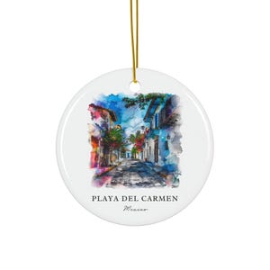 May include: A watercolour-style illustration of a street scene in Playa del Carmen, Mexico. The street is lined with colourful buildings and lush greenery. The text "Playa del Carmen, Mexico" is printed below the image.