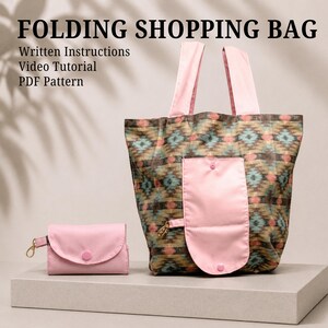 May include: A folding shopping bag with a geometric pattern in shades of brown, teal, and pink, featuring light pink handles and a matching pink pocket. A small, separate pink pouch with a gold clasp is included. Text reads: FOLDING SHOPPING BAG, Written Instructions, Video Tutorial, PDF Pattern.