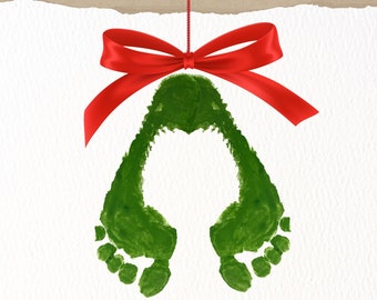 May include: A Christmas card with a green footprint ornament hanging from a red ribbon. The card has the text "Warm wishes & mistletoe kisses" written in black cursive.