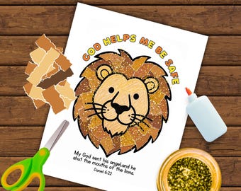 May include: A torn paper craft kit featuring a lion head illustration on white paper with the text "GOD HELPS ME BE SAFE" and "My God sent his angel, and he shut the mouths of the lions. Daniel 6:22". Includes brown paper scraps, glue, and scissors.