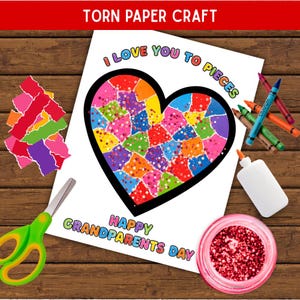 Puede incluir: Un kit de manualidades con papel rasgado que incluye una hoja blanca con un corazón grande de contorno negro relleno de trozos de papel de colores, el texto I LOVE YOU TO PIECES y HAPPY GRANDPARENTS DAY, tijeras verdes, pegamento, ceras y purpurina roja.