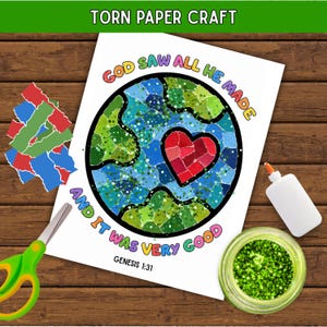 May include: A torn paper craft activity sheet featuring a circular earth design with a red heart, surrounded by the text "GOD SAW ALL HE MADE AND IT WAS VERY GOOD" and "GENESIS 1:31". Includes green scissors, a glue bottle, and green glitter.