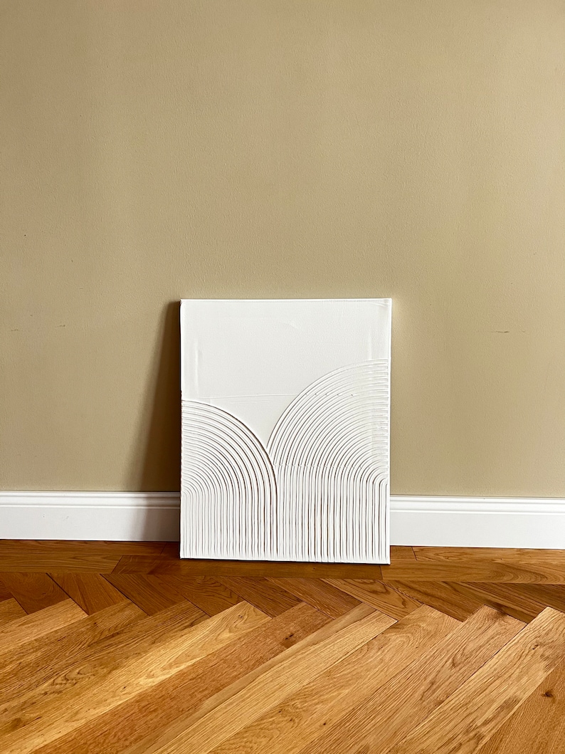 May include: White abstract painting with a textured, raised design of curved lines on a canvas.