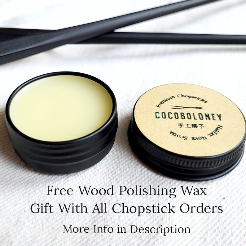 May include: A small tin of wood polishing wax with a black lid. The label on the tin reads "Premium Chopsticks COCOBOLONEY 手工模子 Handmade"
