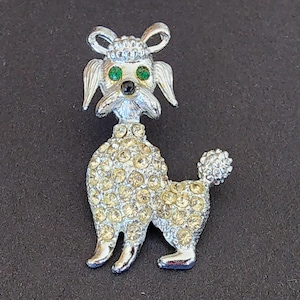 Vintage silver tone rhinestone poodle green eyes brooch