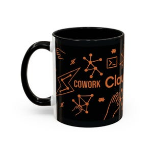 May include: Black coffee mug with a black handle and rim. The mug features orange graphics and the word "COWORK" and "Cloud" in orange. The design includes geometric shapes and symbols.