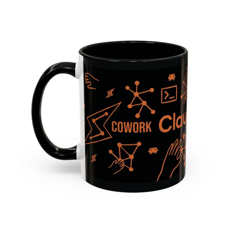 May include: Black coffee mug with a black handle and rim. The mug features orange graphics and the word "COWORK" and "Cloud" in orange. The design includes geometric shapes and symbols.
