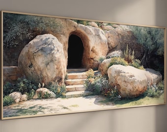 May include: A framed watercolor painting depicts a stone cave entrance with steps leading up to it. Large boulders and lush greenery surround the cave, with a warm, natural color palette.