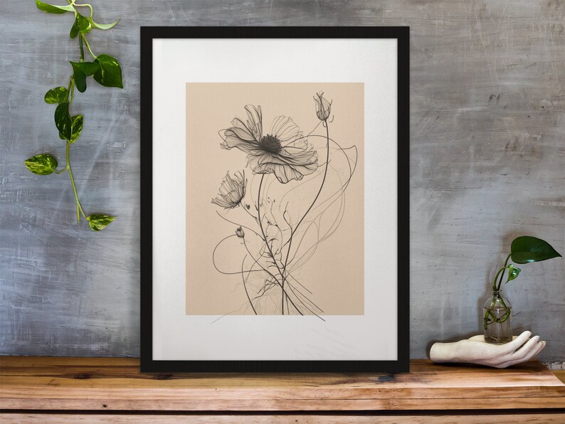 以下が含まれることがあります： シンプルなフレームの中に描かれた、白黒の線画の宇宙の花。花は繊細で、薄い茶色の背景になっています。