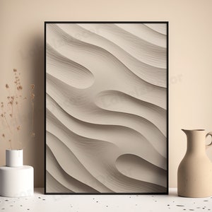 May include: A framed abstract print with a beige background and a wavy, textured pattern. The print is in a black frame and is hanging on a beige wall.
