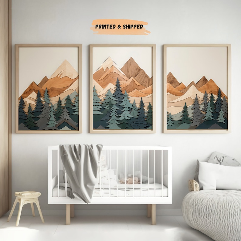 May include: Three framed prints of a mountain landscape with a layered wood effect. The mountains are in shades of brown and orange, and the trees are in shades of green and blue. The prints are arranged in a row on a white wall.