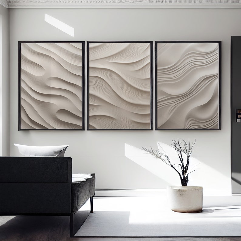 May include: Three framed abstract art prints with a white and gray wavy pattern. The prints are hanging on a white wall in a modern living room.