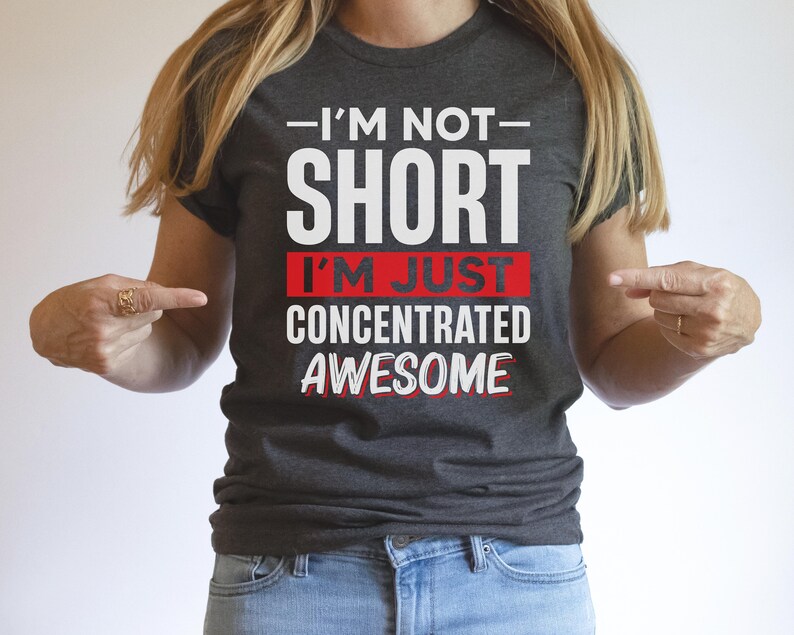 May include: A dark gray t-shirt with white text that reads "I'm not short I'm just concentrated awesome" with the words "I'm just" in red.