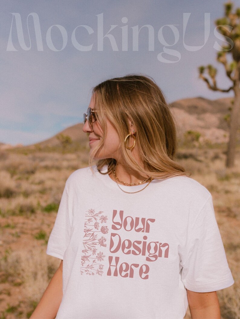 May include: A white t-shirt with a pink floral design and the text 'Your Design Here'.