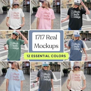 May include: A collection of t-shirts in various colors, each featuring the text "Mockinglis Design" in a floral design. The image also includes the text "1717 Real Mockups" and "12 Essential Colors".