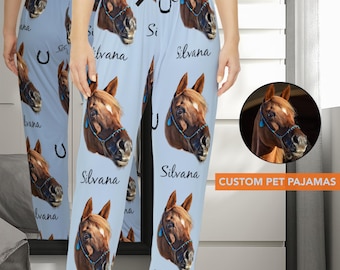 May include: Blue pajama pants with a repeated pattern of a horse's head and the name "Silvana". The horse's head is brown with a blue halter. The text "CUSTOM PET PAJAMAS" is at the bottom of the image.