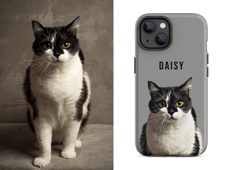 May include: A black and white cat with yellow eyes sits next to a gray phone case. The phone case features a portrait of the cat with the name "DAISY" printed above the image. The cat has a white chest and paws.