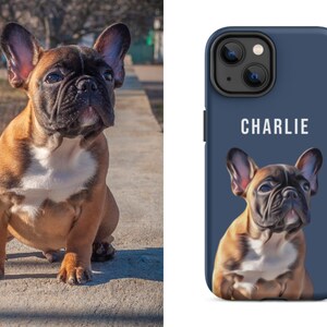 May include: A brown and black French Bulldog puppy sitting outdoors. The dog has a white chest and a black muzzle. A phone case with a navy blue background features a portrait of the dog and the name "CHARLIE" in white.