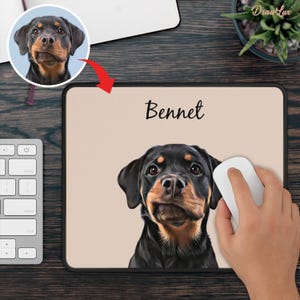 May include: Custom mousepad featuring a Rottweiler dog portrait with the name "Bennet" in black script. The mousepad has a black border and a beige background. A white computer mouse is next to the mousepad.