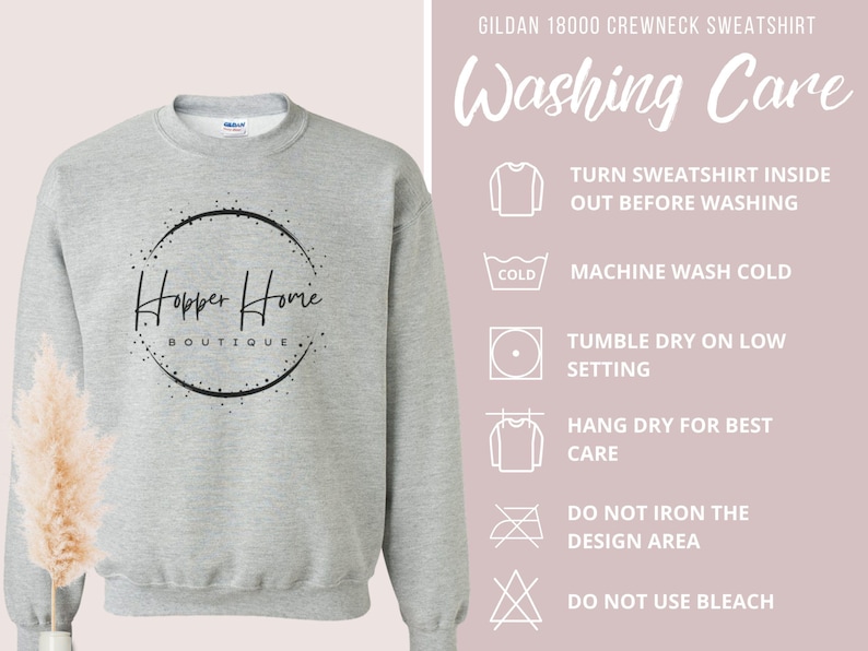 May include: A light gray Gildan 18000 crewneck sweatshirt with the text "Hopper Home Boutique" in a black circular design. Washing instructions are displayed on the right side of the image.