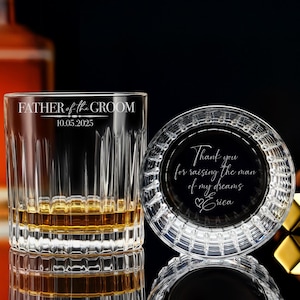 May include: Two engraved crystal glasses, one a rocks glass with the text "Father of the Groom 10.05.2025" and the other a coaster with the text "Thank you for raising the man of my dreams Erica".