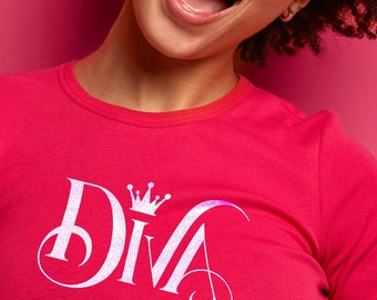 May include: A woman wearing a bright pink t-shirt with a white sparkly "DIVA" graphic with a crown on top.