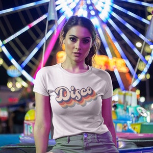 White t-shirt with a colorful 'Disco' print, the bright design contrasting sharply with the light fabric.