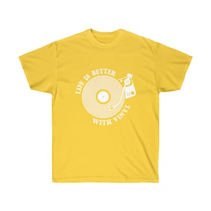 Vibrant yellow t-shirt featuring a turntable design, representing the passion for oldies music and vinyl records.