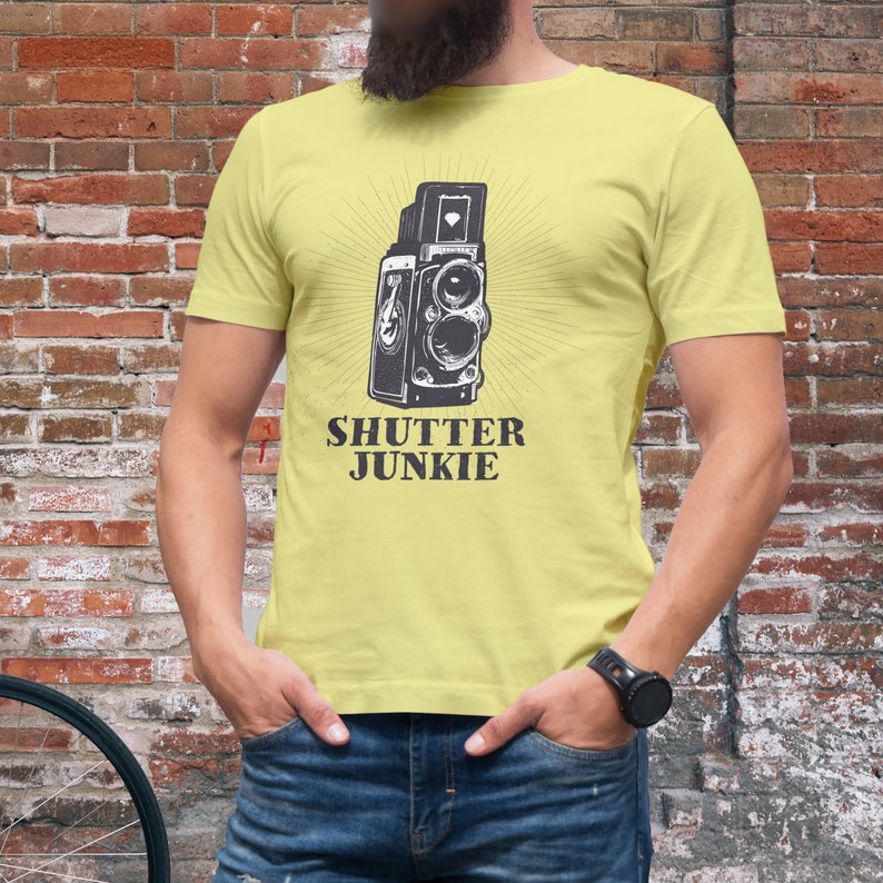 Yellow t-shirt with a vintage camera image and "Shutter Junkie" text.