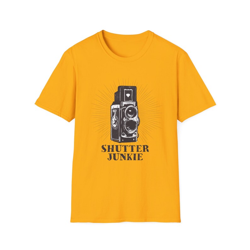 Dark yellow t-shirt featuring a retro camera design and "Shutter Junkie" text.