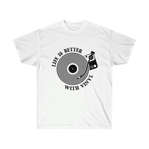 White t-shirt displaying a detailed vinyl record player graphic, perfect for music fans and vinyl collectors.