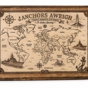 May include: A rectangular wooden wall plaque featuring a laser-engraved world map with the text Anchors Aweigh, Collect Moments, Not Things, and A Sailor Journey. The design includes illustrations of a compass, lighthouse, ships, and an anchor.