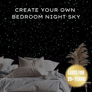 May include: A bedroom scene with a black wall speckled with glowing green stars. The text "CREATE YOUR OWN BEDROOM NIGHT SKY" is at the top. A bed with white bedding and pillows is in the foreground. A gold circle with the text "LASTS FOR 20+ YEARS!" is on the right.