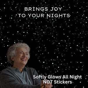 May include: Image features an older adult smiling, set against a starry night sky. Text reads "BRINGS JOY TO YOUR NIGHTS" and "Softly Glows All Night NOT Stickers."