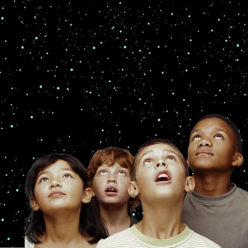 May include: Four children of diverse ethnicities gaze upward with expressions of wonder. The background is a black expanse dotted with small, light green stars. The children are looking up at the stars.